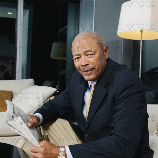 Black businessman reading newspaper