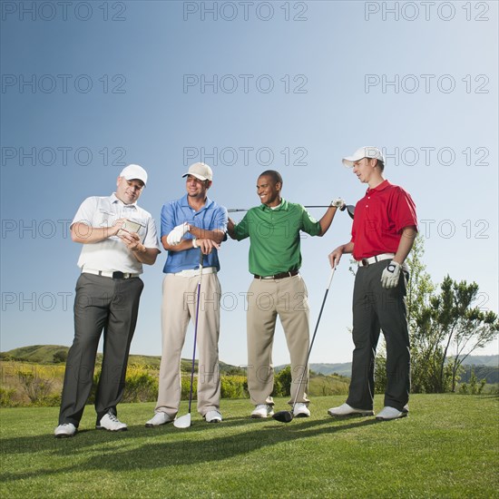 Men playing golf together on golf course