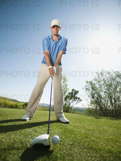 Caucasian golfer preparing to swing golf club