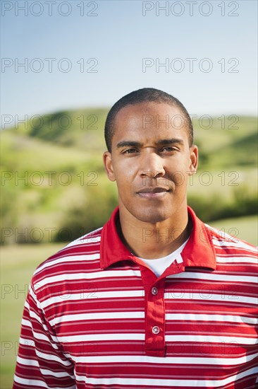 Serious Black man standing outdoors