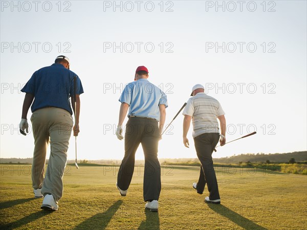 Golfers walking together on golf course
