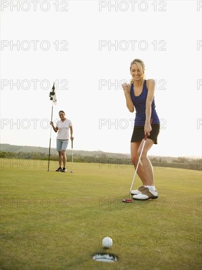 Caucasian golfer cheering on golf course