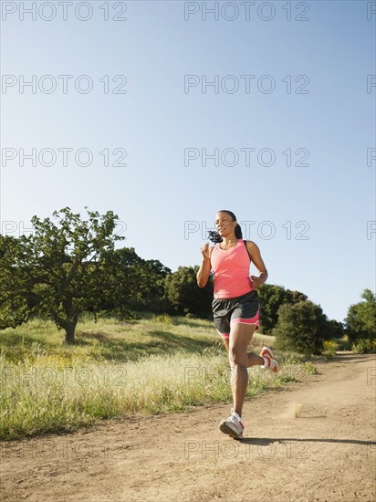 Black woman running on remote trail