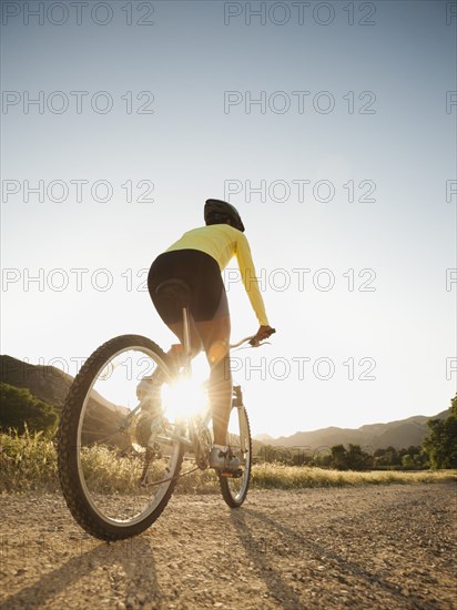 Mixed race woman riding on mountain bike