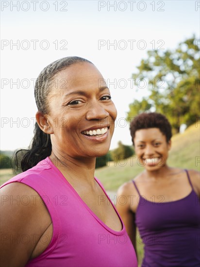 Smiling friends standing together outdoors