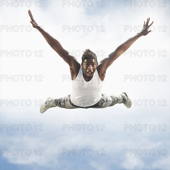 African American man jumping in mid-air