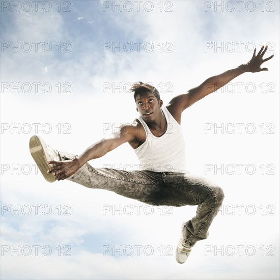 African American man jumping in mid-air