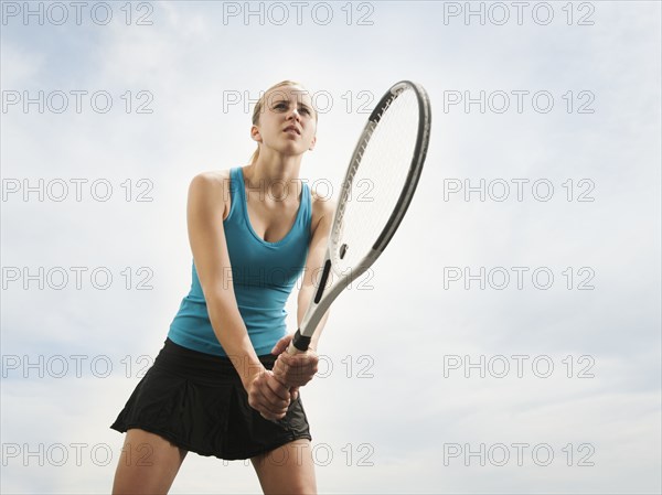 Caucasian woman playing tennis