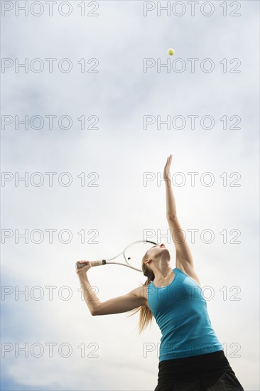 Caucasian woman playing tennis