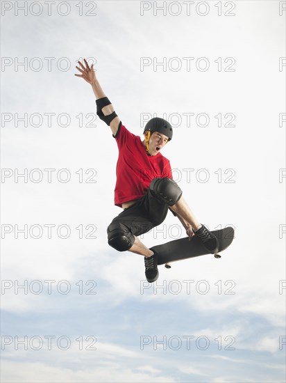 Caucasian man on skateboard in mid-air