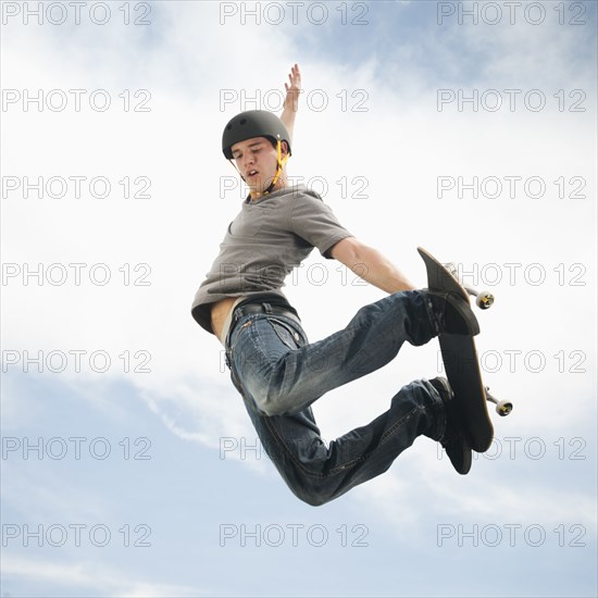 Caucasian man on skateboard in mid-air