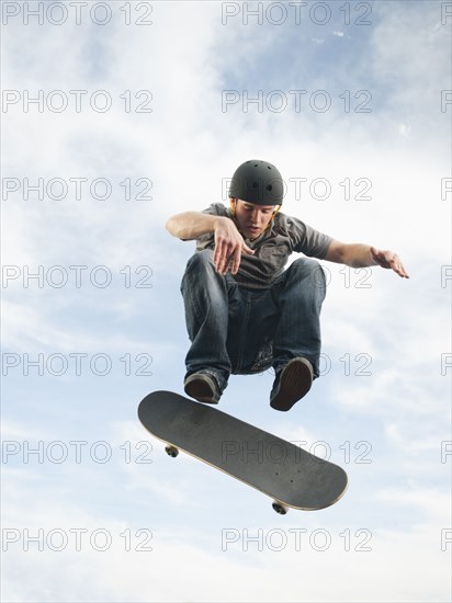 Caucasian man on skateboard in mid-air