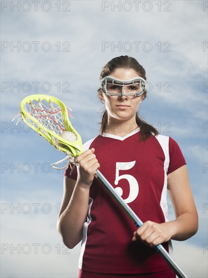 Caucasian teenage lacrosse player