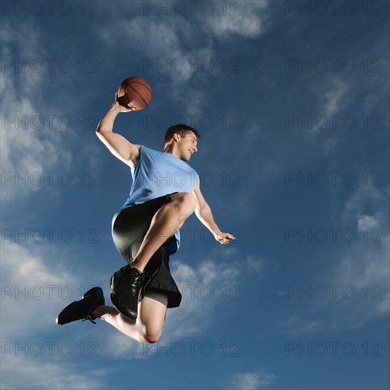 Caucasian man playing basketball