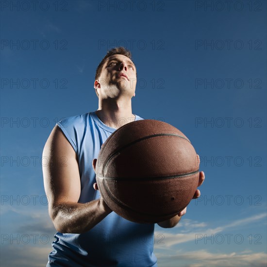 Caucasian man playing basketball