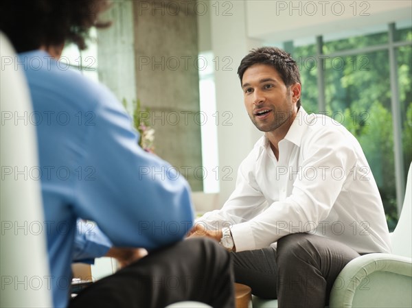 Businessmen talking together in lobby