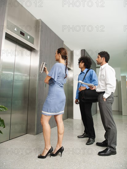 Business people waiting for elevator