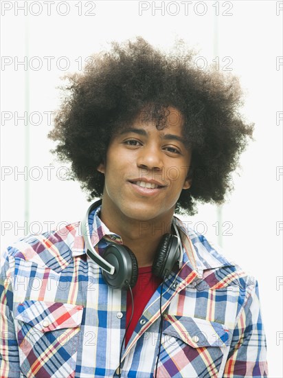 Black man with headphones around neck