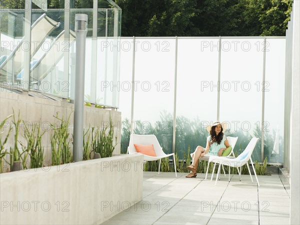 Mixed race woman relaxing on patio