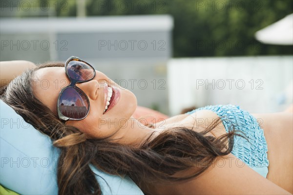 Mixed race woman sunbathing