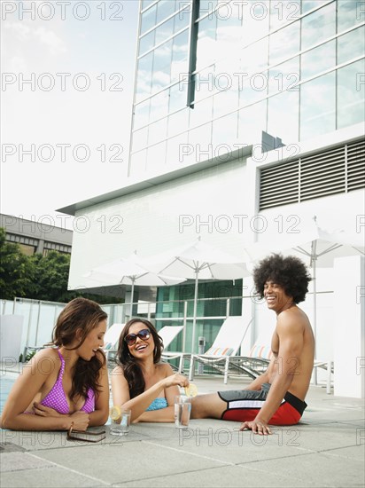 Friends hanging out as poolside