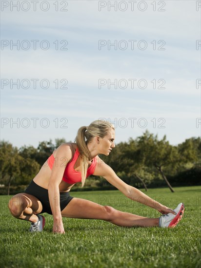 Caucasian woman stretching before exercise