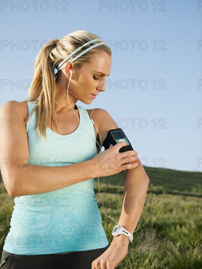 Caucasian woman starting mp3 player before exercise