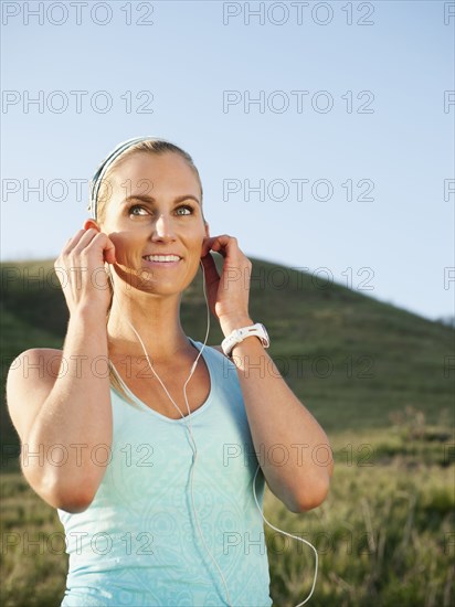 Caucasian woman listening to mp3 player before exercise