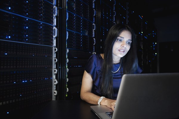 Indian businesswoman working in server room