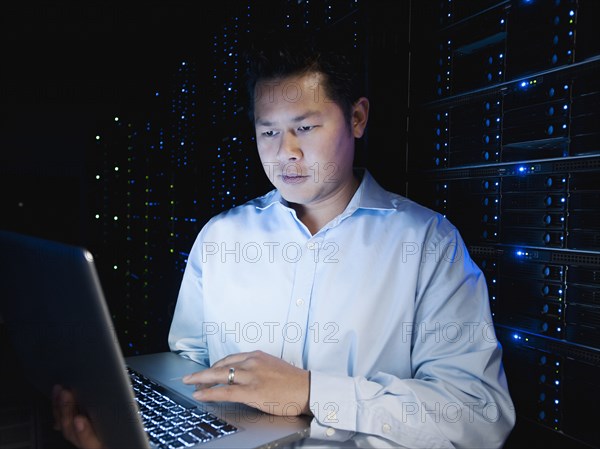 Asian businessman working in server room