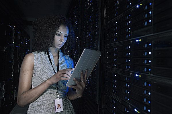 African American businesswoman working in server room