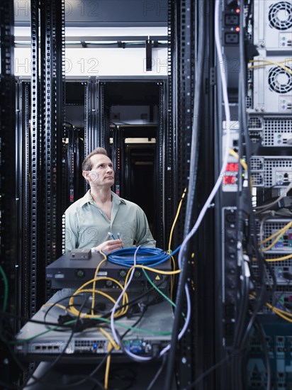 Caucasian businessman working in server room