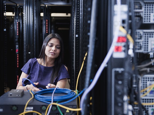 Indian businesswoman working in server room