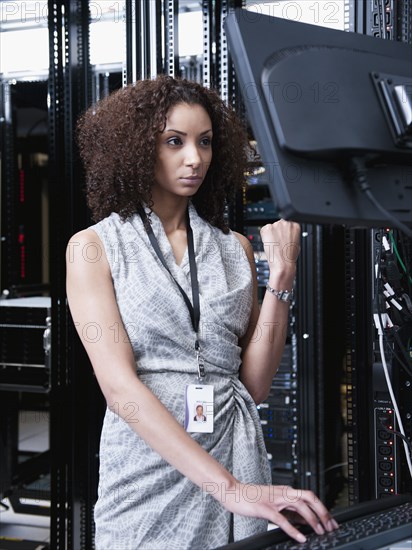 Black businesswoman working in server room