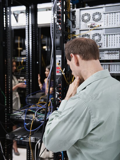 Caucasian businessman working in server room