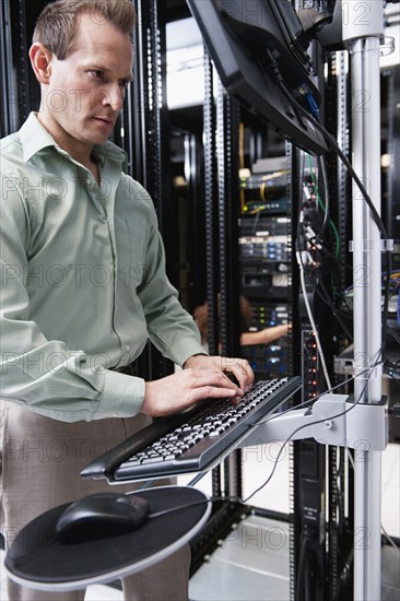 Caucasian businessman working in server room