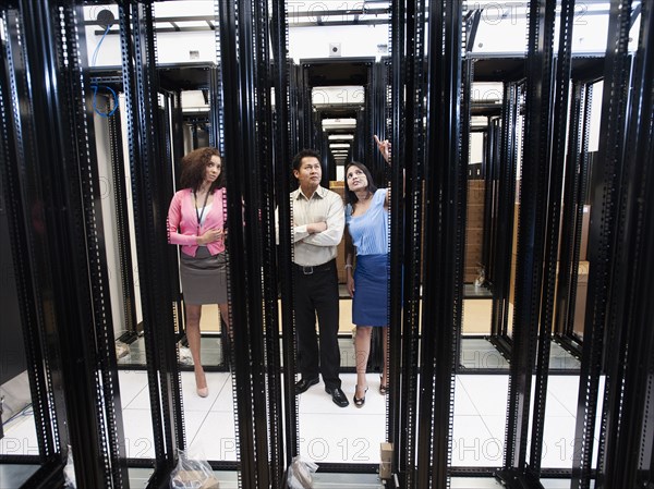 Business people talking in server room