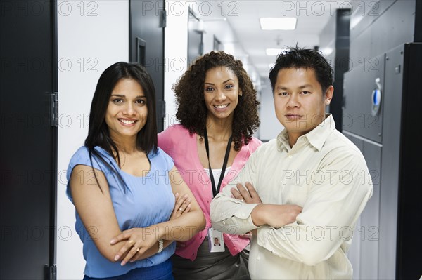 Business people standing in server room