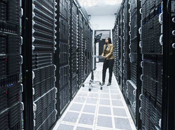 Business people working in server room