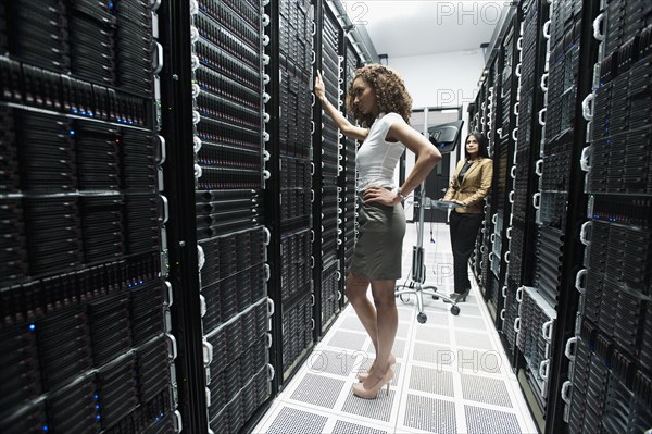 Businesswomen working in server room