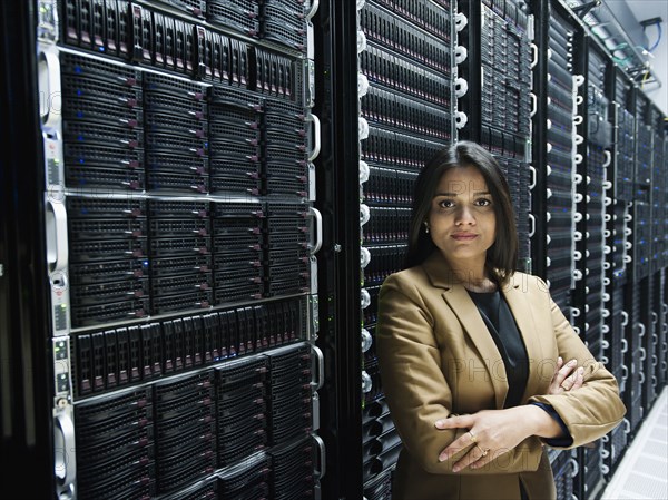 Indian businesswoman standing in server room