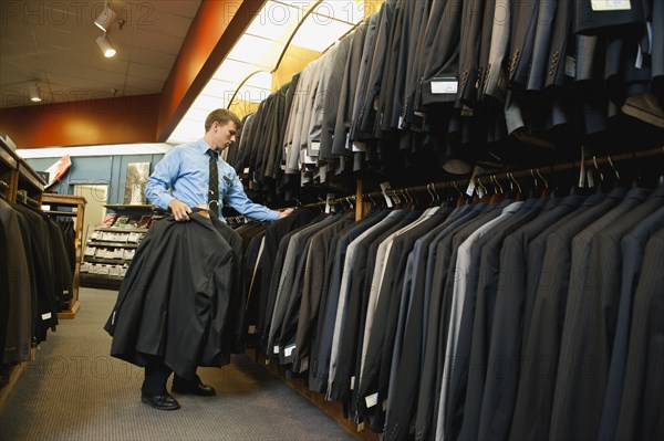 Caucasian man working in men's clothing store