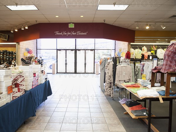 Clothes and shoes displayed in clothing store