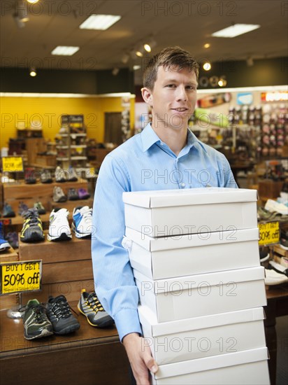 Caucasian man working in shoe store