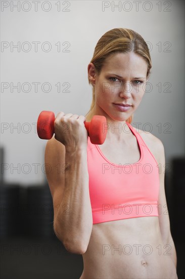 Caucasian woman using dumbbell