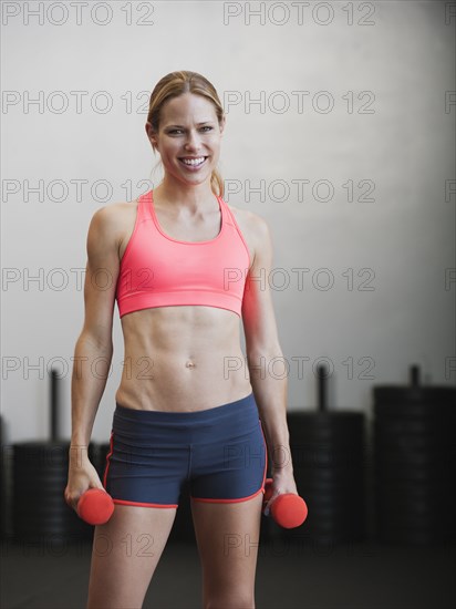 Caucasian woman using dumbbells