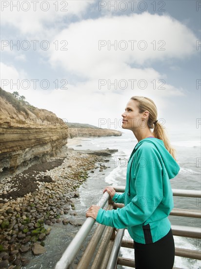 Caucasian woman standing near ocean