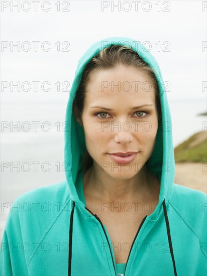 Serious Caucasian woman wearing hooded jacket