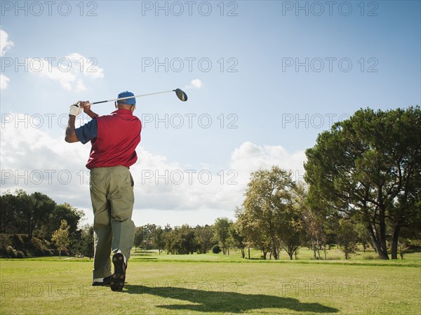 Black man playing golf