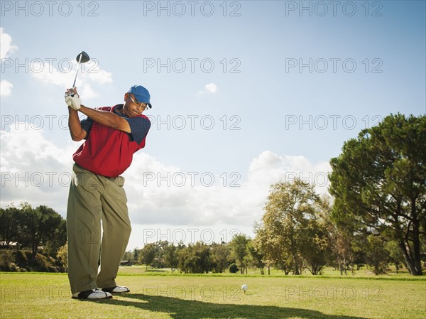 Black man playing golf